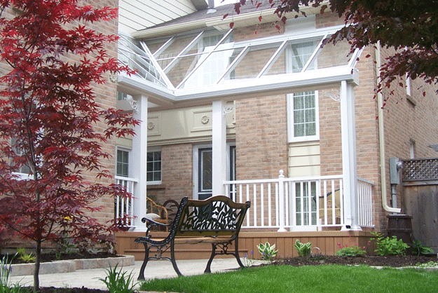 glass canopy on a house in a backyard garden