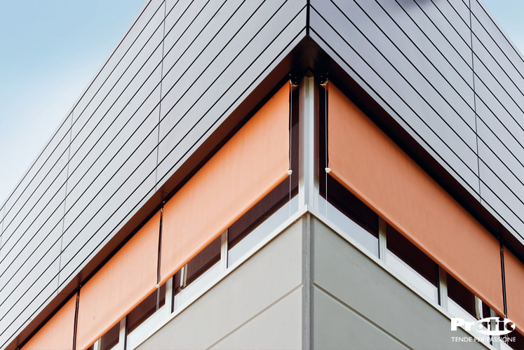 orange retractable window shades blocking heat and light from the sun